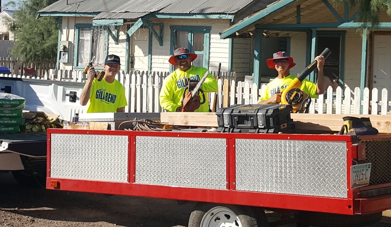 Local volunteers pose before gettin to work on the property behind them
